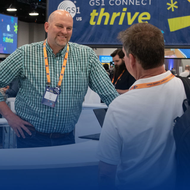 Two conference attendees talking in an exhibit hall