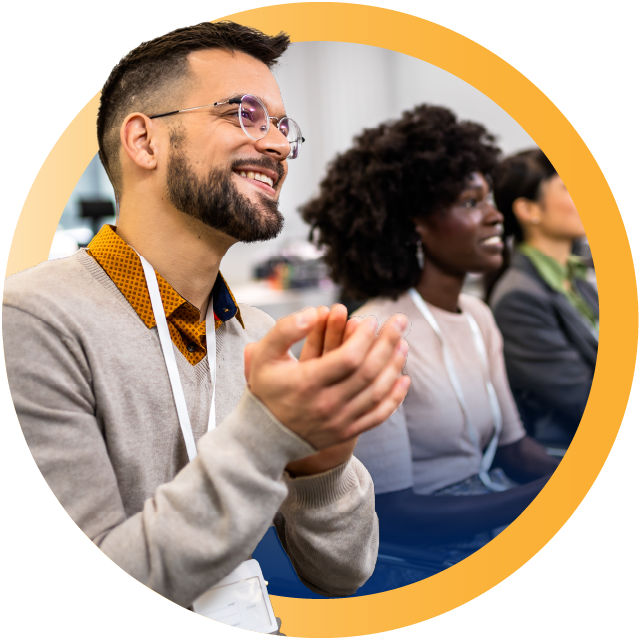 Conference attendee clapping during session