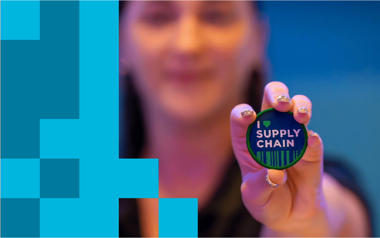Person holding "I heart supply chain" pin
