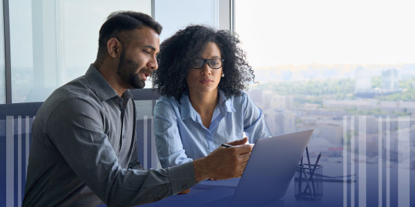 Two people reviewing data on a laptop together  