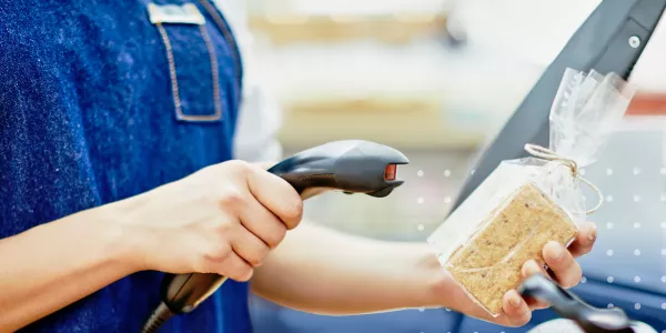 Photo of cashier scanning grocery item at checkout