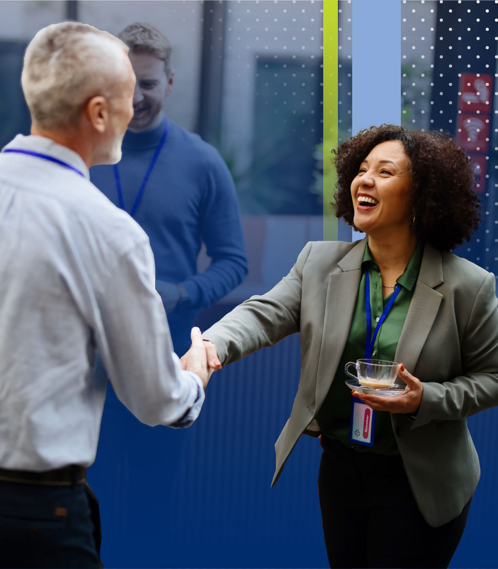 People greeting each other at networking event.