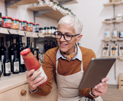 Small business owner checking product information with tablet