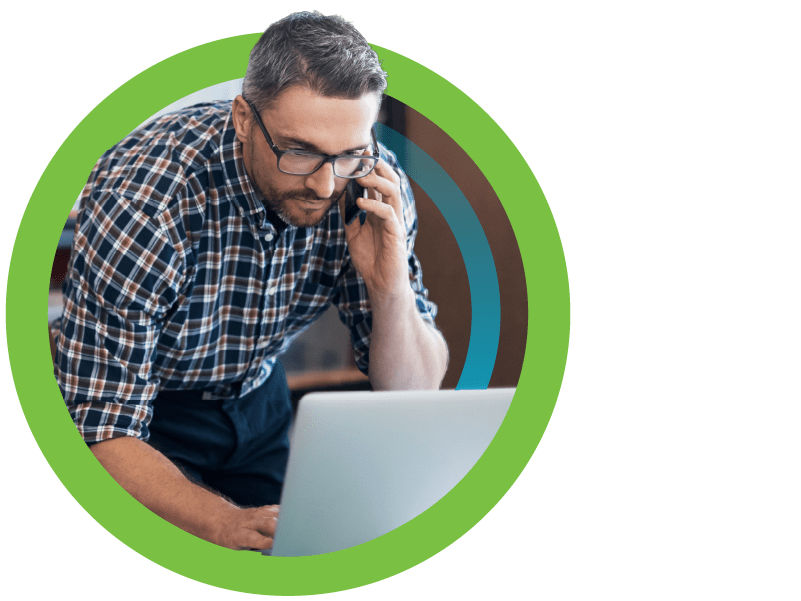 business owner working on laptop and making a phone call ready to license more identifiers