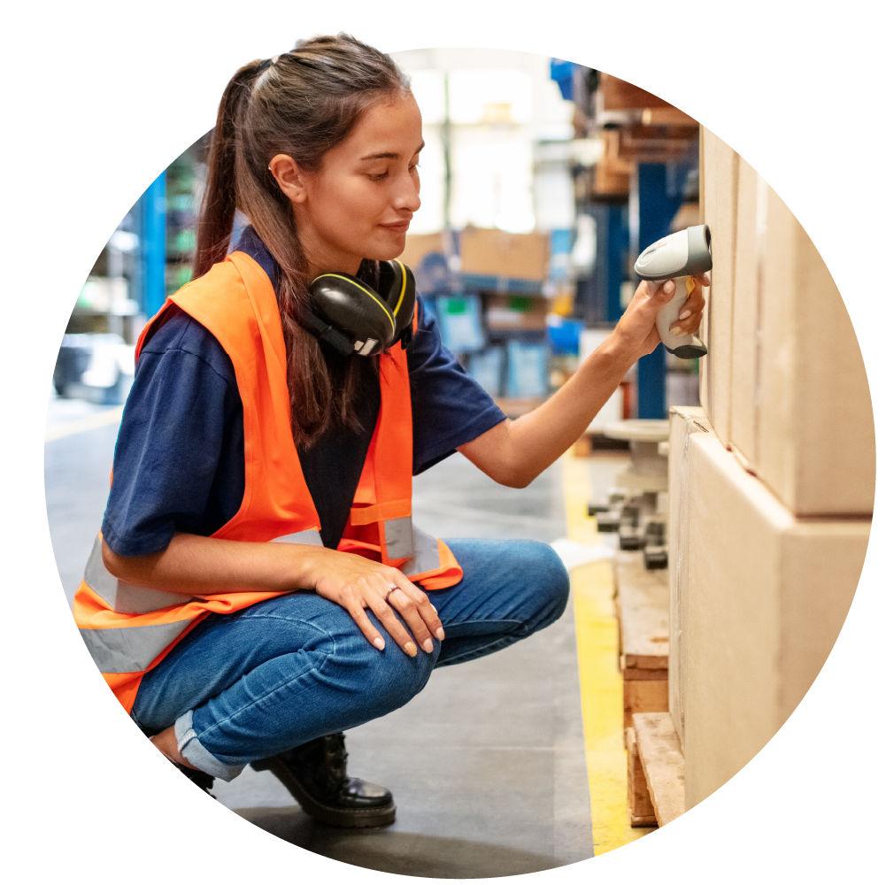 person working in a warehouse scanning boxes