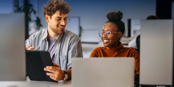 Two people working on computers    