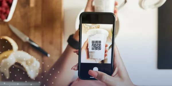 Photo of person scanning QR code on food container
