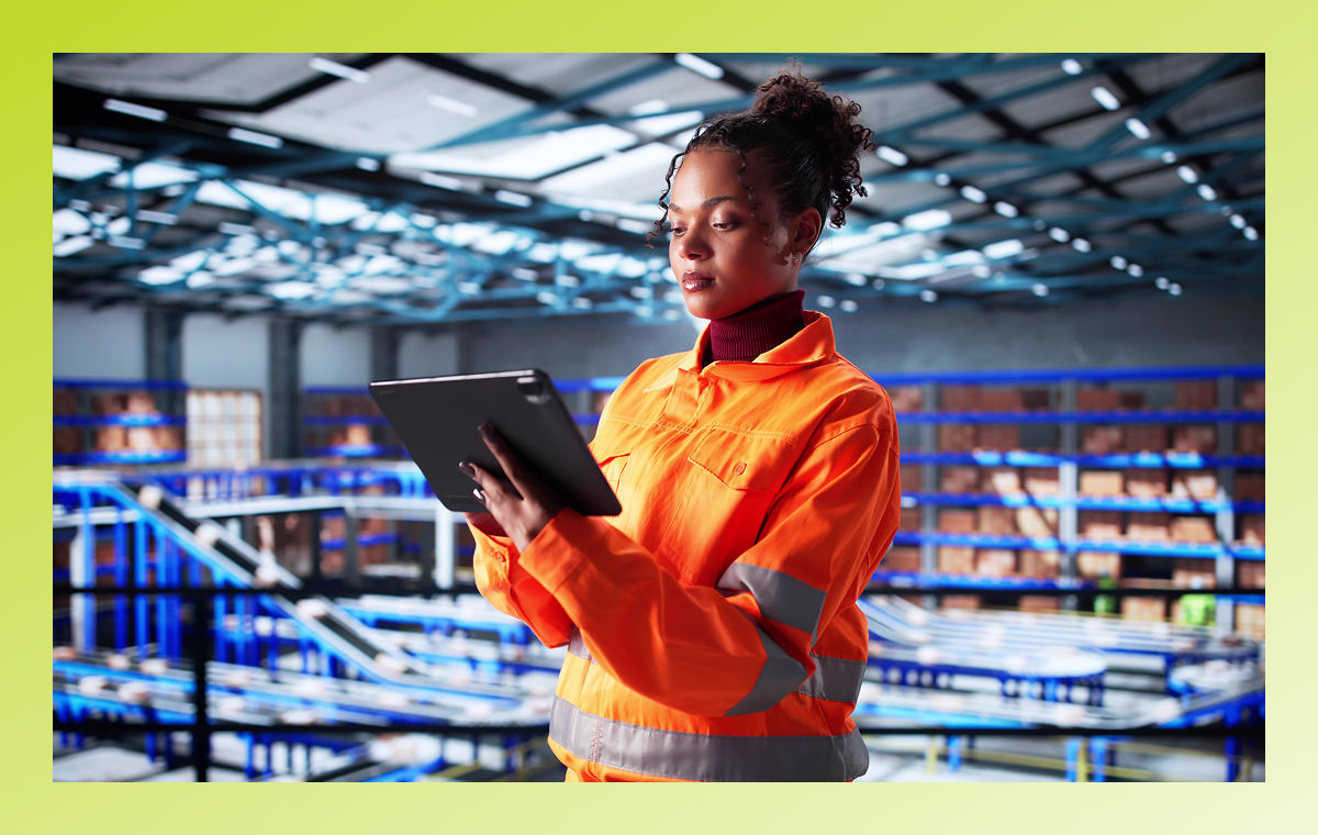 warehouse worker with tablet reviewing data in warehouse