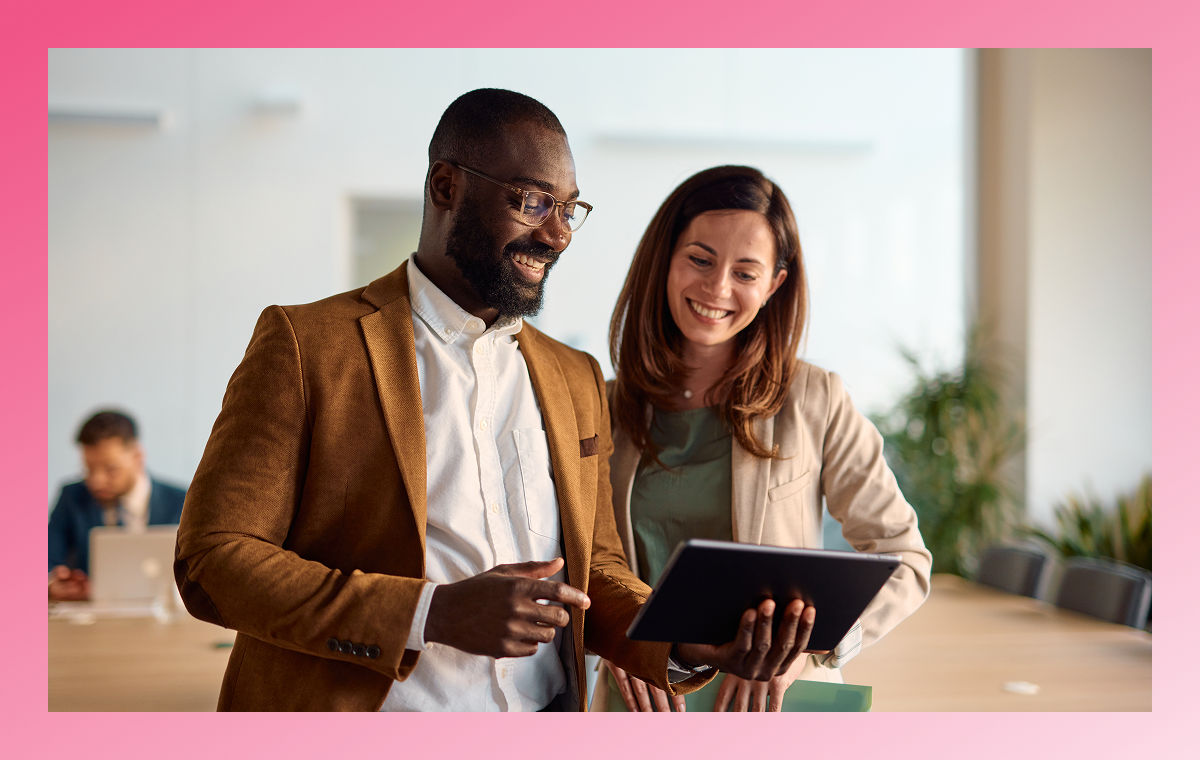 two people working on tablet in office setting