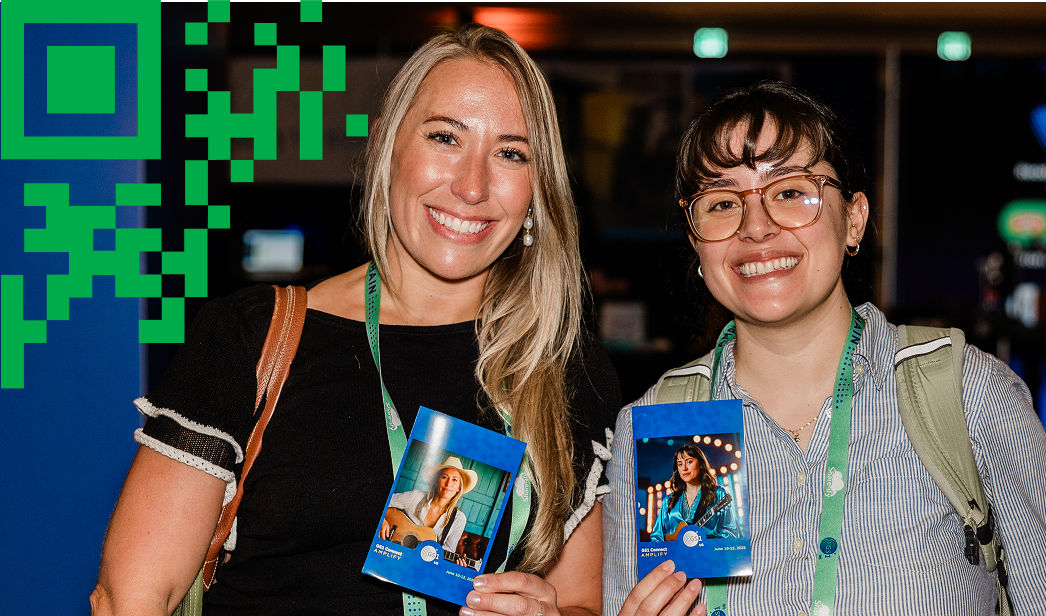 Two conference attendees smiling