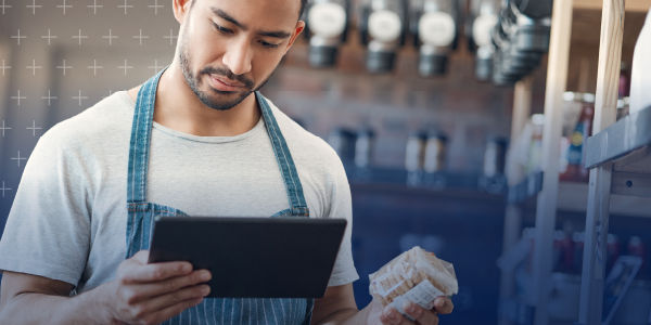 Small businesss owner viewing product data on ipad