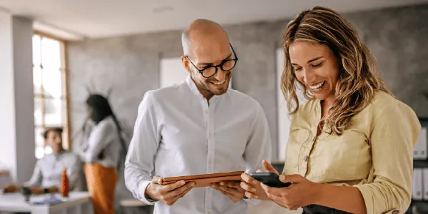 two people reviewing course details on a tablet