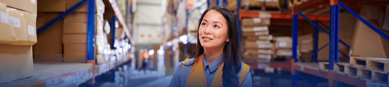 Worker surveys inventory in a warehouse