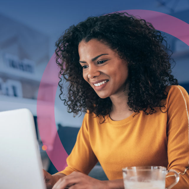 Person working on computer and smiling