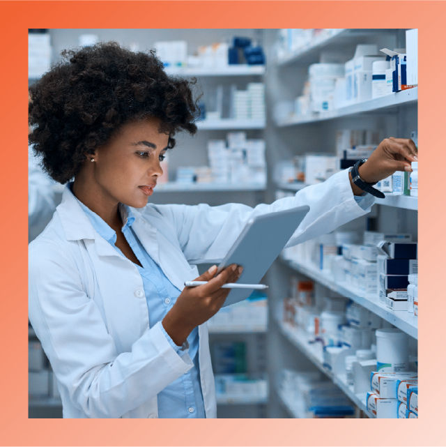 Pharmacist reviewing medications and data with tablet