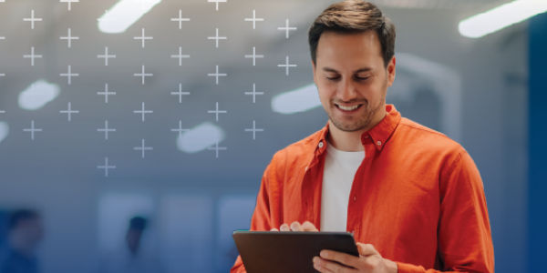 Small business owner surrounded by boxes with laptop and phone