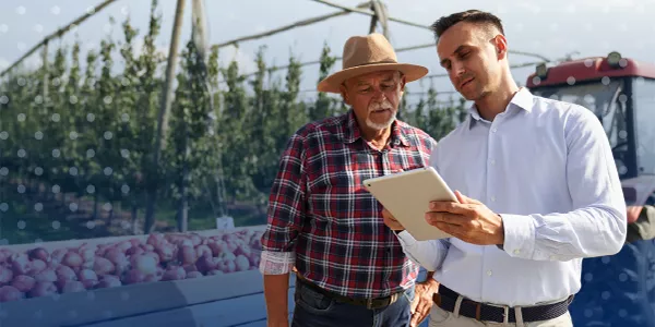 farmer and business man on a farm with a tablet