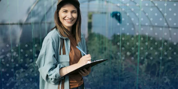 woman in greenhouse with a tablet