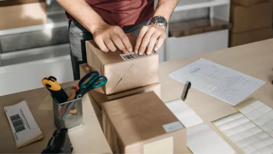 Small business person placing barcode on shipment